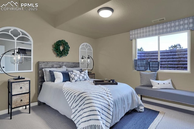 carpeted bedroom with a textured ceiling