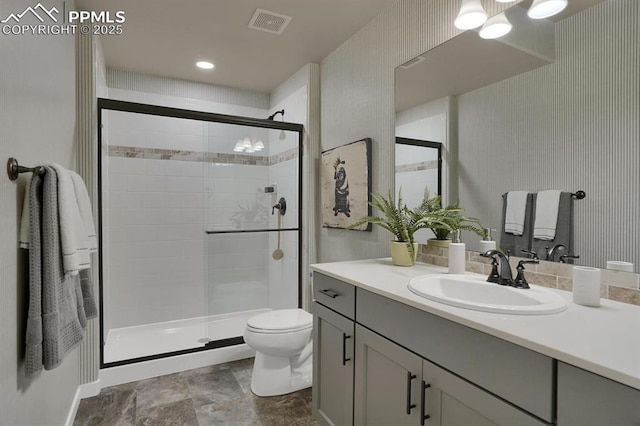 bathroom with vanity, an enclosed shower, and toilet