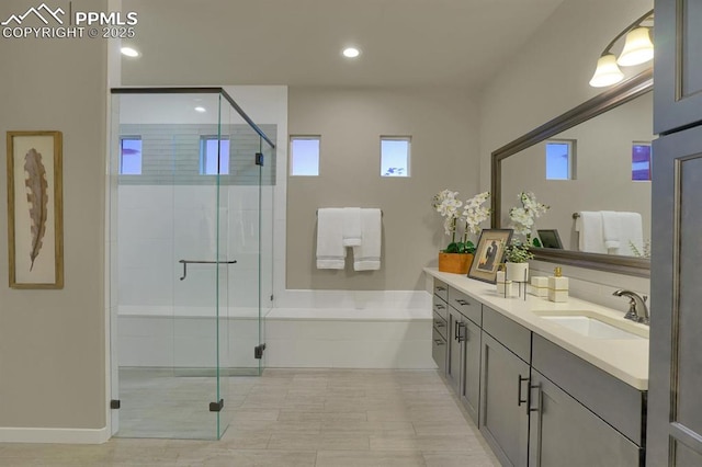 bathroom featuring shower with separate bathtub and vanity