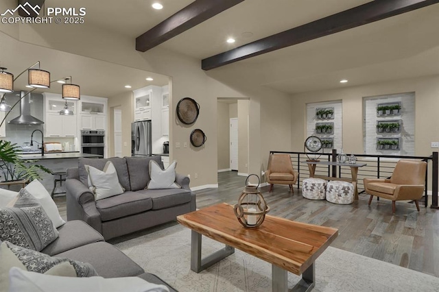 living room with hardwood / wood-style flooring and beam ceiling