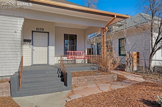 doorway to property featuring covered porch