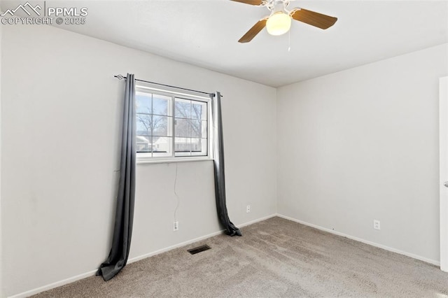 spare room featuring light carpet and ceiling fan