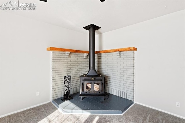 room details featuring carpet and a wood stove