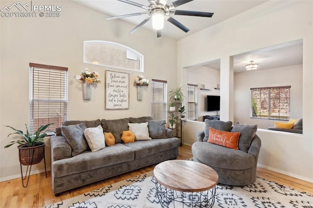 living room featuring light hardwood / wood-style flooring and ceiling fan