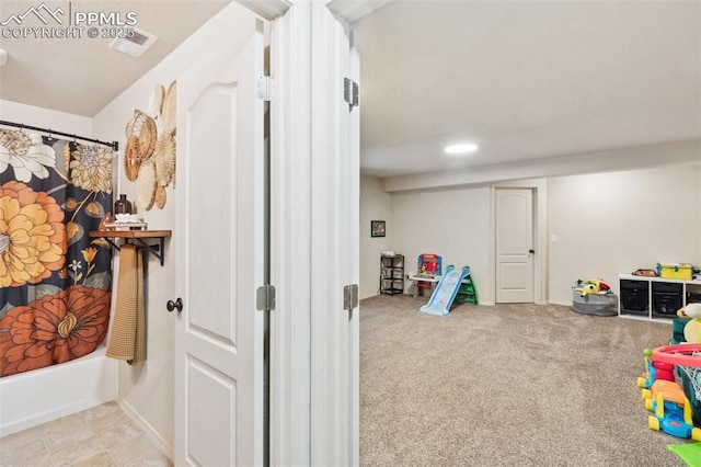 game room featuring light carpet