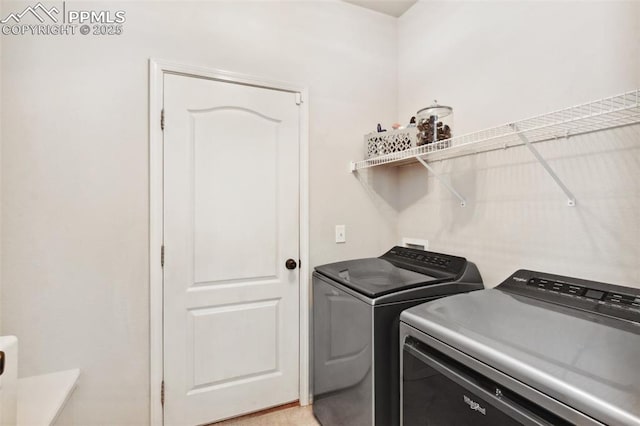 washroom with washing machine and clothes dryer