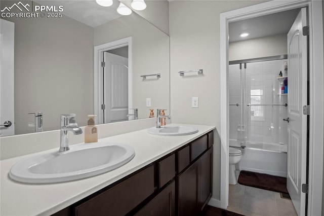 full bathroom with enclosed tub / shower combo, vanity, toilet, and tile patterned floors