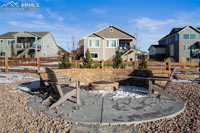 snow covered patio with an outdoor fire pit