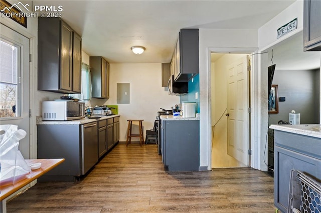 kitchen with hardwood / wood-style flooring, gray cabinetry, stainless steel dishwasher, and electric panel