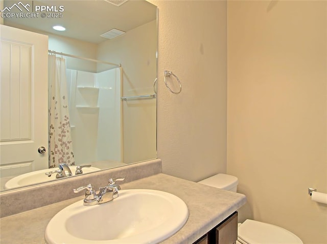 bathroom with vanity, a shower with curtain, and toilet