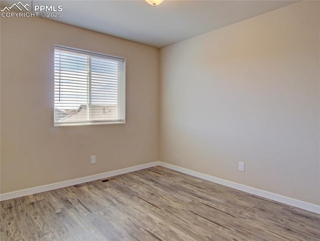 empty room featuring wood-type flooring