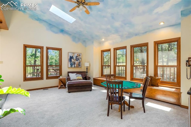 game room with high vaulted ceiling, light carpet, ceiling fan, and a skylight