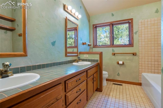 bathroom featuring lofted ceiling, vanity, toilet, and tile patterned flooring