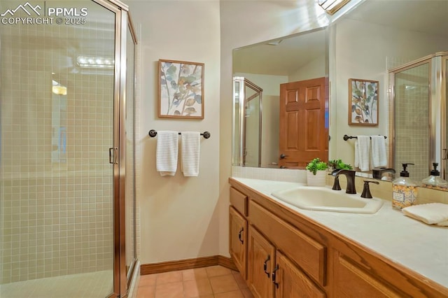 bathroom with tile patterned flooring, vanity, and walk in shower