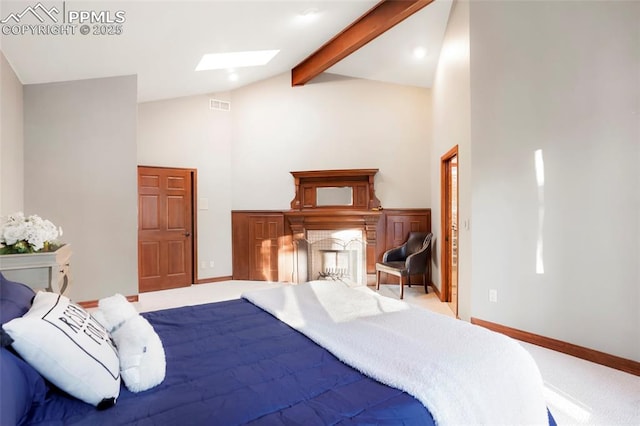 carpeted bedroom featuring beamed ceiling, a skylight, and high vaulted ceiling