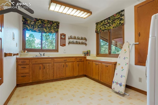 kitchen with sink and white refrigerator