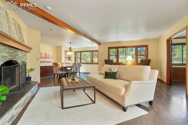 living room featuring hardwood / wood-style floors, a wealth of natural light, and beam ceiling