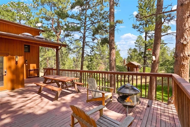 deck featuring an outdoor fire pit