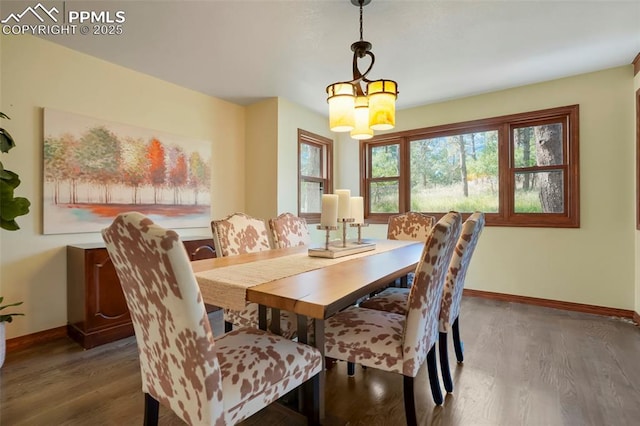 dining area featuring dark hardwood / wood-style flooring and a notable chandelier