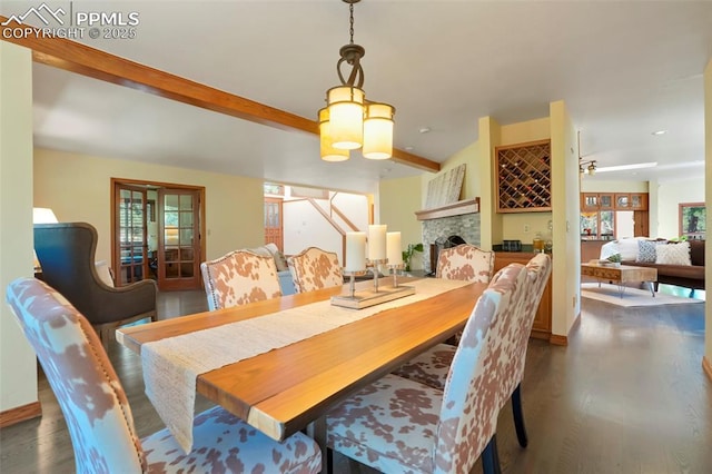 dining room featuring beamed ceiling, ceiling fan, and dark hardwood / wood-style floors