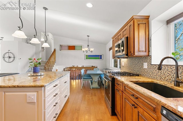 kitchen featuring light stone countertops, white cabinetry, appliances with stainless steel finishes, and sink