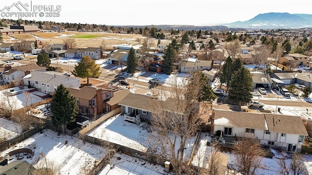 snowy aerial view featuring a mountain view