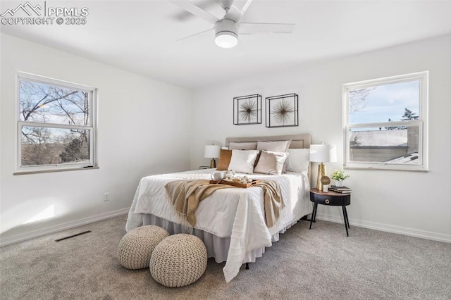 bedroom with multiple windows, ceiling fan, and carpet