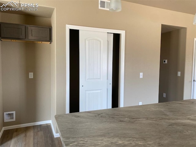 unfurnished bedroom featuring hardwood / wood-style floors and a closet