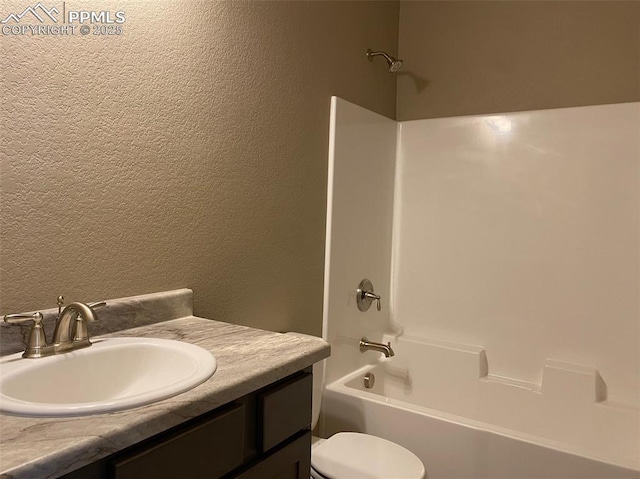 full bathroom featuring vanity, shower / washtub combination, and toilet