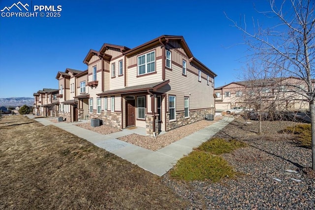 back of property with a yard and central AC unit