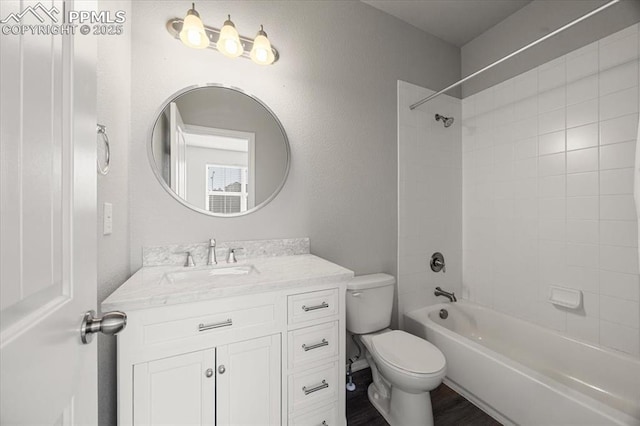 full bathroom with tiled shower / bath, vanity, toilet, and wood-type flooring