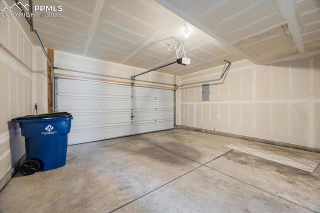 garage with a garage door opener and electric panel