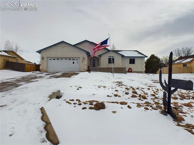 ranch-style house with a garage and stucco siding