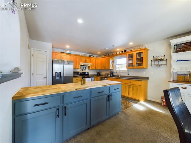 kitchen with recessed lighting, stainless steel appliances, a sink, wood counters, and dark carpet