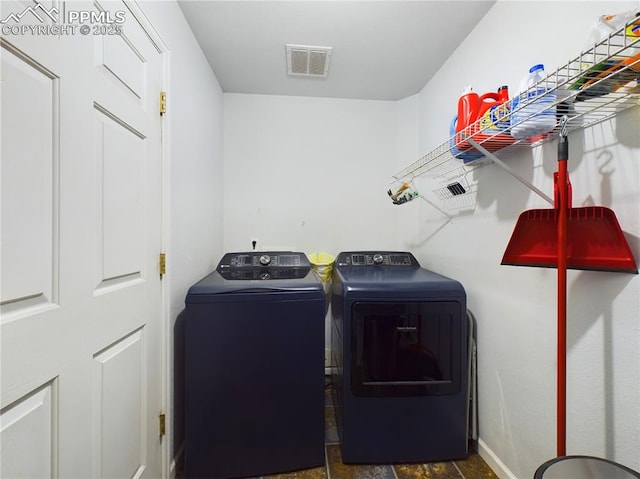 laundry room with laundry area, visible vents, and washer and clothes dryer