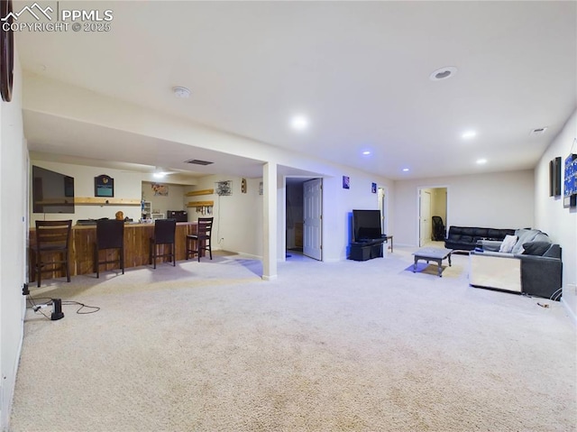 living room featuring visible vents, a dry bar, light colored carpet, and recessed lighting