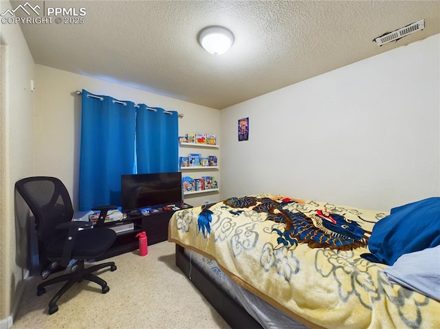 bedroom featuring visible vents and a textured ceiling