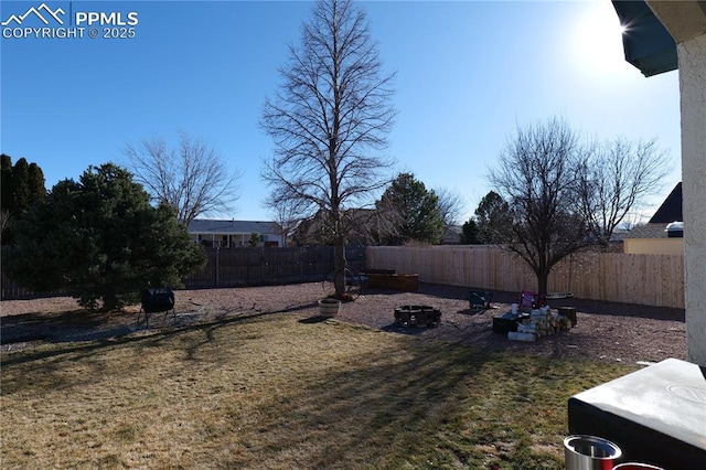 view of yard with an outdoor fire pit and a fenced backyard