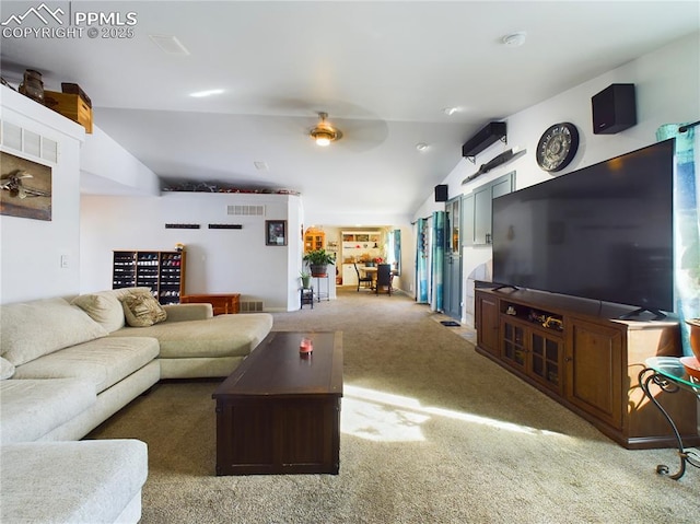 living room with visible vents, vaulted ceiling, and carpet flooring