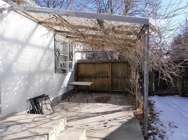 snow covered patio with cooling unit