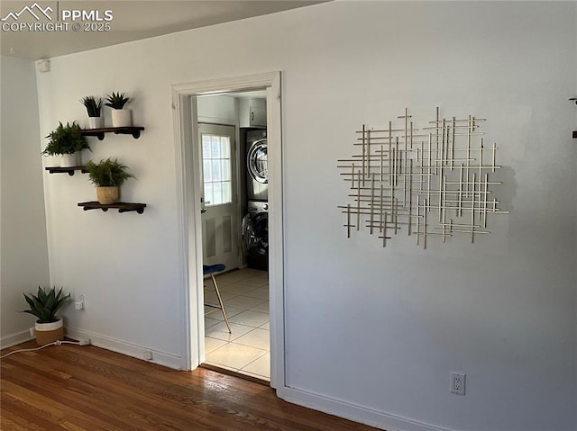 unfurnished dining area with stacked washer / drying machine and dark hardwood / wood-style flooring