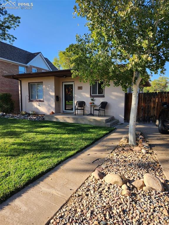 ranch-style home with a patio and a front yard