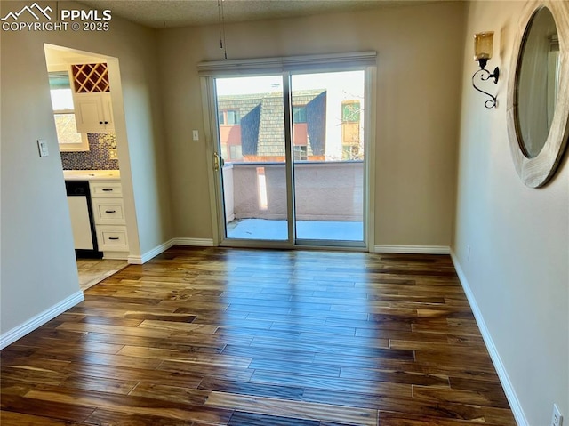 unfurnished room featuring dark hardwood / wood-style flooring