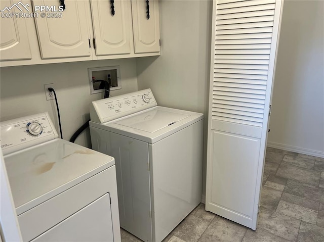 washroom featuring washing machine and dryer and cabinets