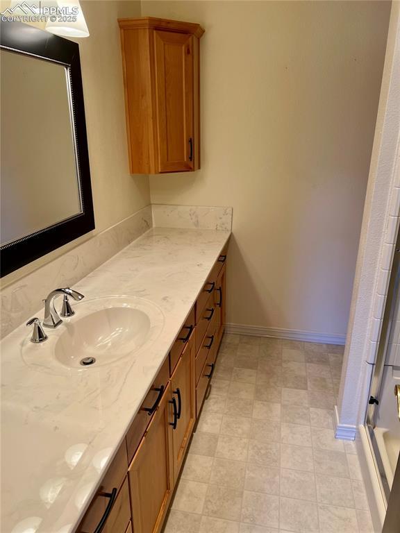 bathroom with a shower with door and vanity