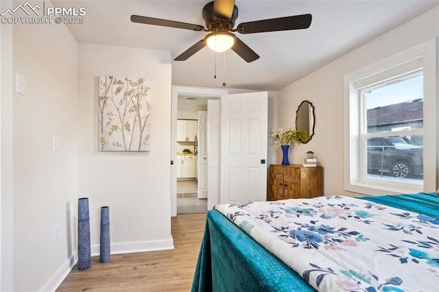 bedroom with ceiling fan and light hardwood / wood-style floors