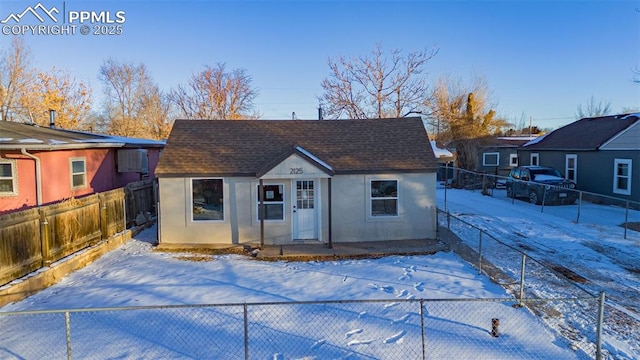 view of snow covered rear of property