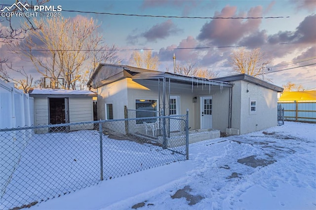 view of front of house featuring a storage unit