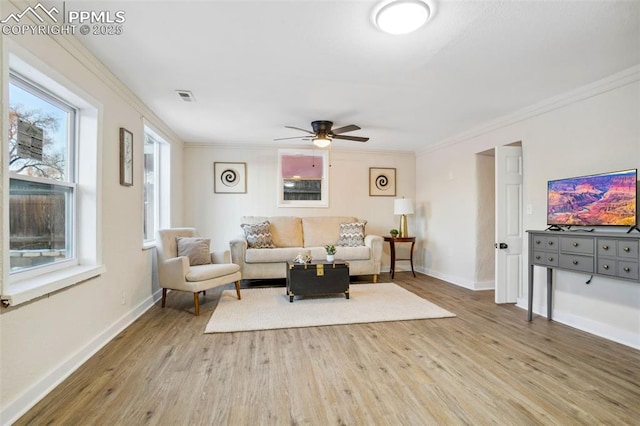 living room featuring ceiling fan, ornamental molding, and wood-type flooring