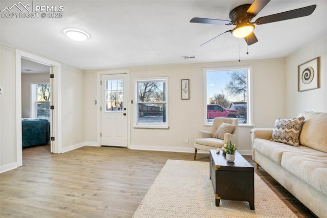 living room featuring light hardwood / wood-style flooring and ceiling fan